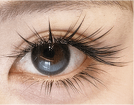 Close-up of a wispy lash extension set with uneven, textured lengths